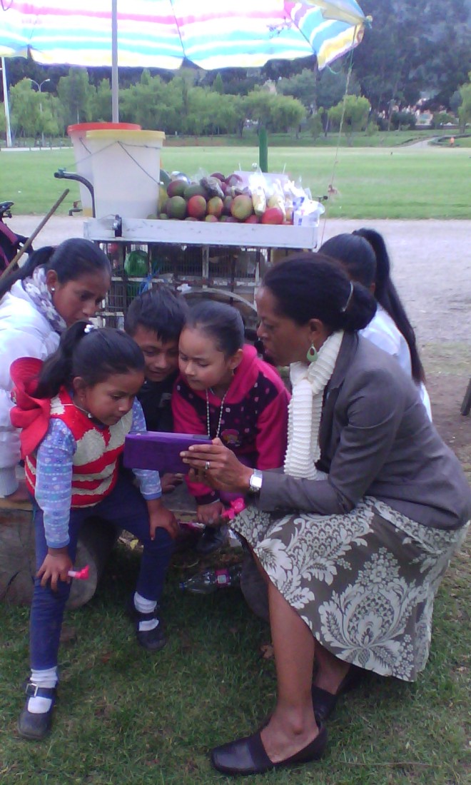 Chet captures a moment showing videos to some sweet kids in Parque  Paraiso, they took a break from working on their fruit wagon.